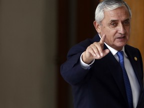 In this Monday, Aug. 31, 2015, file photo, Guatemala's President Otto Perez Molina acknowledges reporters at the end of a press conference, in Guatemala City. Guatemala's attorney general said Wednesday, Sep. 2, 2015, that a judge has granted her request for an order to detain President Otto Perez Molina in connection with a government corruption case that has thrown the country into turmoil. (AP Photo/Moises Castillo, File)