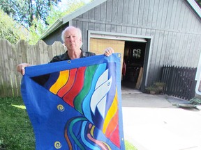Artist David Moore is shown in this file photo holding a banner he created for the Sarnia-Lambton Suicide Prevention Committee. Moore is scheduled to speak at the committee's World Suicide Prevention Day event Sept. 10, 6:30 p.m., being held at the band shell in Canatara Park. File photo/THE OBSERVER/Postmedia Network