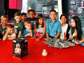 Fans at Good Morning America join EvanTubeHD, center, a digital star from the Maker Studios network, after he unboxed the LEGO Star Wars Millennium Falcon and the Star Wars BB-8 App Enabled Droid from Sphero on "Good Morning America" in New York, Sept. 3, 2015, as part of the epic global event marking the countdown to "Force Friday" when merchandise from Star Wars: The Force Awakens goes on sale. (Photo by Stuart Ramson/Invision for Disney Consumer Products/AP Images)