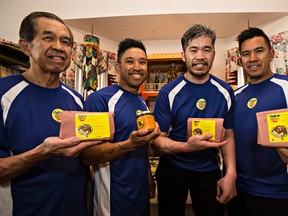 (From left) Chee Liaw and his sons, Alex, Albert and Allen, pose for a photo at Liaw's home in Edmonton, Alta. on Monday, Aug. 31, 2015. The family are the proprietors of Golomein, a company that makes and sells noodles and sauces at the Strathcona Farmer's Market. Albert had a stroke a few years ago and has worked hard to regain his mobility. Albert is now the CFO and VP of marketing in the family business. Codie McLachlan/Edmonton Sun