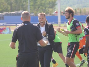 Ottawa Fury FC head coach Marc Dos Santos celebrates his team's 1-0 victory over FC Edmonton with assistant coach Martin Nash in Fort McMurray Alta. on Sunday August 2, 2015. Robert Murray/Fort McMurray Today/Postmedia Network