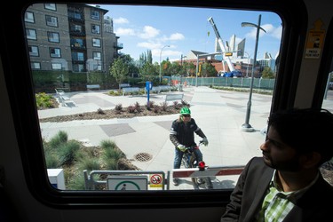 A cyclist is seen from the window of a LRT train during a media tour of the new Metro LRT line in Edmonton, Alta., on Thursday September 3, 2015. The LRT extension will open on Sunday, Sept. 6 cost a total of $665 million to build and connects Churchill Station to NAIT. Ian Kucerak/Edmonton Sun/Postmedia Network