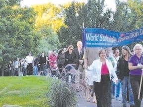 Participants walk through the Civic Garden during the 2012 Lifting the Silence event. The next Lifting the Silence Memorial Walk and Ceremony is planned for Thursday in Victoria Park. (Submitted photo)