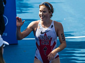 Canada's Paula Findlay crosses the finish line during the 2014 ITU World Triathlon Grand Final Edmonton elite women's race at Hawrelak Park in Edmonton, Alta., on Saturday, Aug. 30, 2014. Codie McLachlan/Edmonton Sun