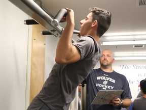 First overall draft pick David Levin takes part in fitness testing under the watchful eye of Sudbury Wolves athletic therapist Dan Buckland during the opening day of Wolves training camp at Sudbury Community Arena on Thursday September 3, 2015.