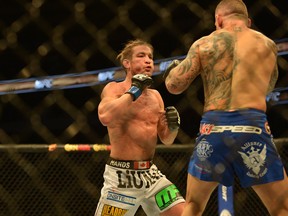 Sam Stout fights Ross Pearson in a UFC bout in Dallas in March. Stout lost his last three fights and has decided to retire. (File photo)