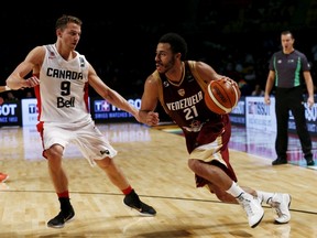 Venezuela's Dwight Lewis Padron (right) dribbles the ball past Canada's Nik Stauskas during their FIBA Americas Championship game in Mexico City on Thursday, Sept. 3, 2015. (Henry Romero/Reuters)