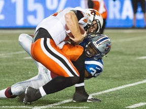 Lions quarterback Travis Lulay is tackled by Alouettes' Kyries Hebert during first half CFL action in Montreal on Thursday, Sept. 3, 2015. (Graham Hughes/THE CANADIAN PRESS)