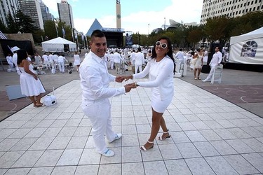 Ronie Mira and Catalina Mejiadamcing dance before dining during the Le Diner en Blanc dinner at Churchill Square in Edmonton, Alberta on September 3, 2015. Perry Mah/Edmonton Sun/Postmedia Network