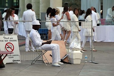 A man wiat to get in the Le Diner en Blanc dinner at Churchill Square in Edmonton, Alberta on September 3, 2015. Perry Mah/Edmonton Sun/Postmedia Network