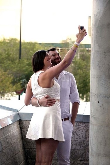 A couple takes a selfie during the Le Diner en Blanc dinner at Churchill Square in Edmonton, Alberta on September 3, 2015. Perry Mah/Edmonton Sun/Postmedia Network