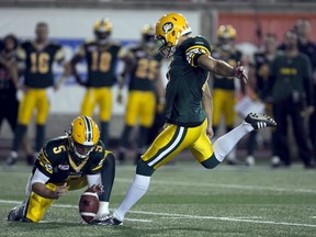 Matt Nichols holds while Grant Shaw kicks the winning field goal against the Alouettes in Montreal in August. With Nichols’ departure, third-string QB Jordan Lynch has been designated Shaw’s new holder. (Reuters)