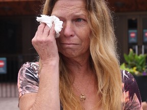Gail Traynor stands weeping outside court on Thursday, Sept. 3, 2015, after hearing the details of how her brother-in-law, Michael Traynor, was killed almost 40 years ago. (TRACY McLAUGHLIN/Special to the Toronto Sun)