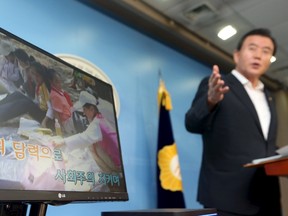 A politician demonstrates a karaoke machine in which a song and footage from North Korea has been installed, in Seoul, South Korea, on Sept. 3, 2015. (REUTERS/Do Kwang-hwan/Yonhap)