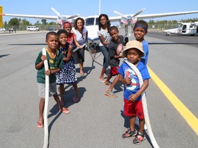 The Nyabeze family, which includes Peter, 7, left, Hope, 5, Charles, 11, Carmen, mom, Kaiya, 13, Gabriel, 10, Isaac, 8, and Abel, 4, help to launch the Canadian Cancer Society's Pulling for Hope 2015 at the Greater Sudbury Airport in Greater Sudbury, Ont. on Thursday September 3, 2015. The fundraiser, which is being held on Sept. 19,  helps to raise money for the Wheels of Hope program which helps cover travel expenses for patients travelling for cancer treatment. Carmen is being supported by the program because she must travel back and forth to the Hospital for Sick Children in Toronto with Abel, who is being treated for cancer. John Lappa/Sudbury Star/Postmedia Network