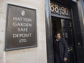 In a file picture taken on April 7, 2015 a man leaves the Hatton Garden Safe Deposit Limited in London. Police on May 19 arrested seven men over an audacious heist in London's diamond district last month. (AFP PHOTO/NIKLAS HALLE'N)