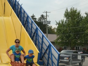 Brady, his brother Carson (right) and their mom Heather Brown took advantage of the short lines at the Mitchell Fall Fair after lunch on Friday, Sept. 4 to ride the giant slide.  GALEN SIMMONS/MITCHELL ADVOCATE