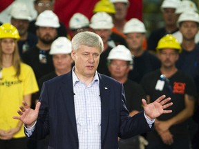 Canada's Prime Minister Stephen Harper listens to a question on the economy as he takes questions during a campaign stop at steel manufacturer Laurel Steel in Burlington, Ont., on Tuesday, September 1, 2015. REUTERS/Fred Thornhill