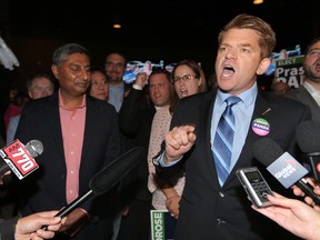 Prasad Panda and Brian Jean celebrate their by-election win in Calgary-Foothills.