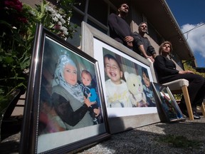 Tima Kurdi, right, aunt of late brothers Alan and Ghalib Kurdi, pauses while speaking to the media outside her home as her son Alan Kerim, left, and husband Rocco Logozzo stand behind her, in Coquitlam, B.C., on Friday September 4, 2015. Alan, his older brother Ghalib and their mother Rehanna died as they tried to reach Europe from Syria. THE CANADIAN PRESS/Darryl Dyck