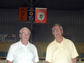 Wallaceburg Hornet Oldtimer players Don Mann, left, and Guy Celotto pose with a banner that was raised at the Wallaceburg Memorial Arena on Aug. 17 that commemorates the Canadian Oldtimers hockey 'D' championship won by the 1980-81 Hornet team in Montreal. Mann and Celotto were members of the team. Ogies Lift Truck donated a truck and their time to help put the banner in place in the arena rafters.