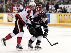 Ottawa 67's first-round pick Austen Keating tries to jump over Gatineau Olympiques defenceman Gabriel Bilodeau as the two teams met for an exhibition game at TD Place on Friday, Sept. 4, 2015. (Chris Hofley/Ottawa Sun)