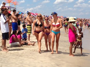 This July 6, 2013 file photo shows beachgoers on the sand in Point Pleasant Beach, N.J.  Stephen Leatherman, a professor at Florida International University known as Dr. Beach, creates an annual list of best beaches and says that beginning in 2016, he’ll give extra points to beaches that ban smoking. (AP Photo/Wayne Parry, File)