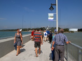 After an official ribbon-cutting ceremony Saturday morning, the public was invited to stroll out on to the refurbished west pier in Port Stanley. The breakwater was closed off in 1998 after three young men died at the site within days of each other. Central Elgin has installed numerous safety devices and barriers to help prevent any similar tragedy from happening. Ian McCallum/Postmedia Network