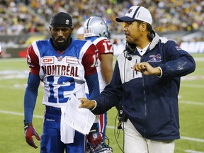 Montreal Alouettes quarterback Rakeem Cato speaks to coach Anthony Calvillo during CFL play against the Hamilton Tiger-Cats  August 27, 2015. (REUTERS/Mark Blinch)