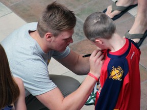 Left-winger Lawson Crouse signs 5-year-old Isaac Fleet's Florida Panthers jersey at the Kingston Frontenacs Fronts Fest at the Cataraqui Centre in Kingston, Ont. on Saturday September 5, 2015. Steph Crosier/Kingston Whig-Standard/Postmedia Network