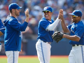 Toronto Blue Jays, from left to right, Marco Estrada, Marcus Stroman, and Ben Revere celebrate the Blue Jays’ win over the Baltimore Orioles in Toronto on Saturday, September 5, 2015. (THE CANADIAN PRESS/Darren Calabrese)