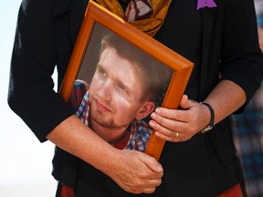 Petra Schulz holds a photo of her son Danny, 25, who died of an overdose during an International Overdose Awareness Day event held outside City Hall in Edmonton, Alta., on Monday August 31, 2015. Organizers advocate for more awareness, medical services and caring towards those struggling with drug use. Ian Kucerak/Edmonton Sun/Postmedia Network