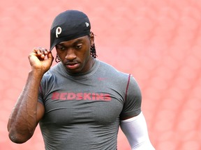 Quarterback Robert Griffin III of the Washington Redskins looks on during warmups before playing against the Jacksonville Jaguars at FedExField on September 3, 2015 in Landover, Maryland. (Patrick Smith/Getty Images/AFP)