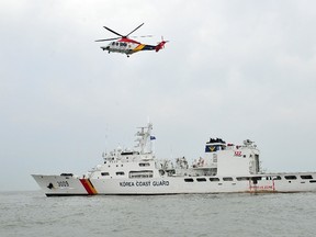 File photo of a South Korean Coast Guard helicopter taking off from its ship on April 19, 2014. AFP PHOTO / JUNG YEON-JE