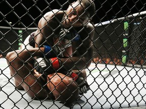 Anthony Johnson, top, fights Jimi Manuwa during their light heavyweight mixed martial arts bout at UFC 191 on Saturday, Sept. 5, 2015, in Las Vegas. (AP Photo/John Locher)