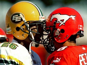 Sept. 2, 2002, Labour Day Classic. Edmonton Eskimos Donny Brady and Calgary Stampeders Kamau Peterson bang heads during the second half of the annual Labour Day Classic at McMahon Stadium on Monday, Sept. 2, 2002. The Eskimos went on to win 28 - 20. Darren Makowichuk/Calgary Sun/Postmedia Network.