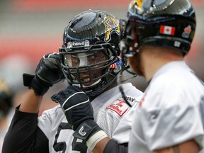 Former Hamilton Tiger-Cats offensive linesman Brian Simmons, recently acquired by the Edmonton Eskimos, (L) during practice at BC Place in Vancouver, BC on Sunday November 23, 2014, ahead of the 102nd CFL Grey Cup. Al Charest/Calgary Sun/QMI Agency