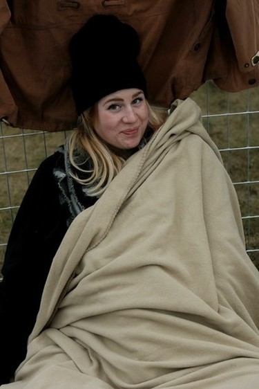 Allison Lilly from Edmonton tries to stay warm as she listens to one of the bands at the 2015 SONiC BOOM Festival in Borden Park in Edmonton on Saturday Sept. 5, 2015. Tom Braid/Edmonton Sun/Postmedia Network.