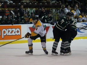 Sarnia Sting forward Jordan Kyrou slips a check, causing London Knights teammates Benjamin Gleason and Aaron Berisha to collide near their blue line. The Sting and Knights faced off in an Ontario Hockey League preseason game Saturday night at RBC Centre. Terry Bridge/Sarnia Observer/Postmedia Network