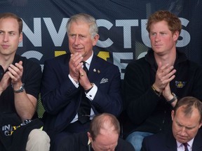 Princes William (L), Charles (C) and Harry applaud during the Invictus Games in London September 11, 2014. (REUTERS/Neil Hall)