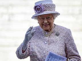 Queen Elizabeth waves as she leaves a Service of Commemoration at St Martin-in-the-Fields church in central London on August 15, 2015, to mark the 70th anniversary of VJ (Victory over Japan) Day. (AFP PHOTO / NIKLAS HALLE'N)