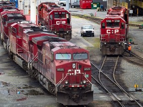 A Canadian Pacific Rail maintenance worker climbs onto a locomotive at the company's Port Coquitlam yard east of Vancouver, B.C., in this May 23, 2012 file photo. THE CANADIAN PRESS/Darryl Dyck