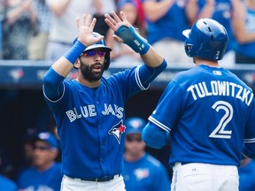 Toronto Blue Jays Jose Bautista, left, and Troy Tulowitzki celebrate Tulowitzki's two-run home run during third inning MLB baseball action against the Baltimore Orioles in Toronto on Sunday, September 6, 2015. THE CANADIAN PRESS/Darren Calabrese