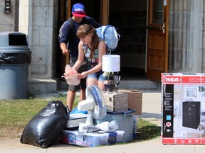 New first year Queen's University general arts and science student Belinda Whyte, 18, loads up boyfriend Solomon Skulijcak while moving in to residence in Kingston, Ont. on Sunday September 6, 2015. Steph Crosier/Kingston Whig-Standard/Postmedia Network