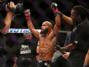 Demetrious Johnson celebrates after defeating John Dodson during their flyweight title mixed martial arts bout at UFC 191, Saturday, Sept. 5, 2015, in Las Vegas. (AP Photo/John Locher)