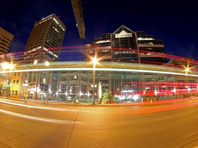 The lights from an ETS bus streak by by Canada Place on Jasper Ave and 97 St on Tuesday evening June 9, 2015 in Edmonton, Alta. Hugo Sanchez/Special to the Edmonton Sun