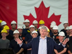 In this Tuesday, Sept. 1, 2015 file photo, Prime Minister Stephen Harper speaks during a campaign stop at a steel manufacturer in Burlington, Ontario, Canada. Canada has long prided itself for opening its doors wider than any nation to asylum seekers, but the number it welcomes has waned since the Conservative leader took power almost 10 years ago. (Adrian Wyld/The Canadian Press via AP)