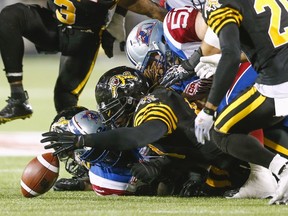 Hamilton Tiger-Cats' Taylor Reed recovers a fumble against the Montreal Alouettes during the first half of their CFL football game in Hamilton, Ontario, Canada, August 27, 2015. REUTERS/Mark Blinch