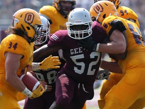 University of Ottawa Gee-Gees defensive lineman Henry Quan tries to make a play on the Queen's Golden Gaels ball carrier Jesse Andrews as the teams opened the season at Gee-Gees Field on Sunday, Sept. 6, 2015. (Chris Hofley/Ottawa Sun)