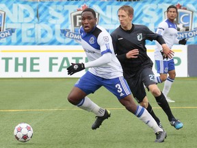 Edmonton's Eddie Edward is pursued by Minnesota's Greg Jordan during FC Edmonton's NASL soccer game against Minnesota United FC at Clarke Stadium in Edmonton, Alta., on Sunday, Sept. 6, 2015. PHOTO BY TONY LEWIS/FC EDMONTON